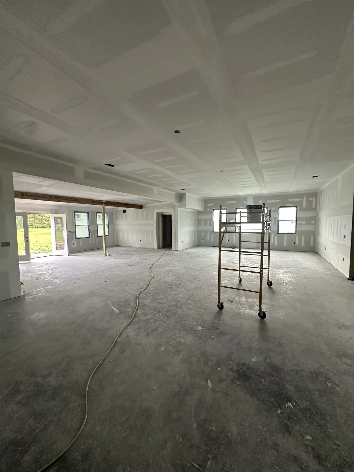 Large interior with newly installed and finished drywall and ceiling