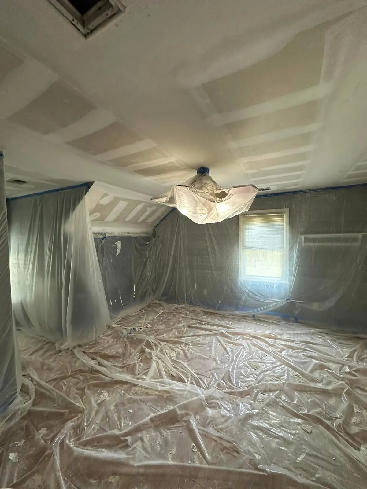 Ceiling being smoothed after popcorn texture removal