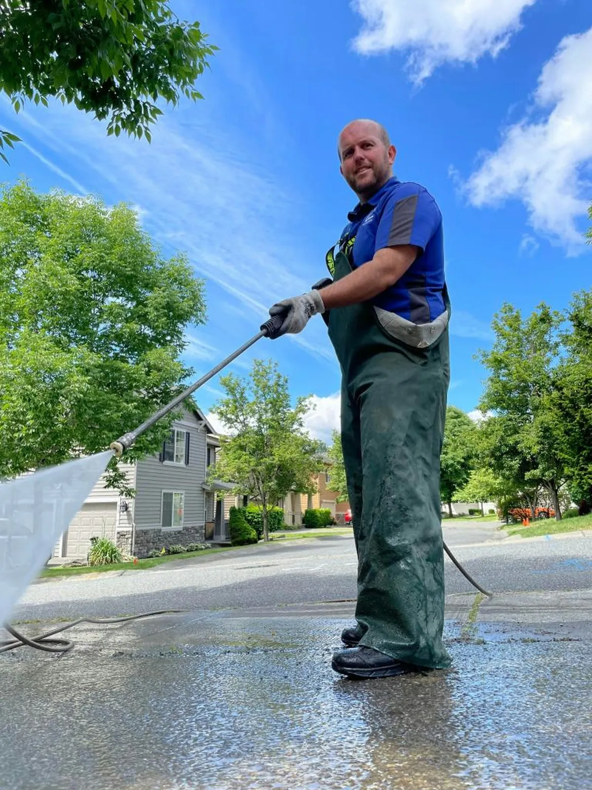 Professional pressure washing a driveway