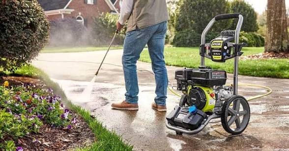 Professional pressure washing a residential driveway